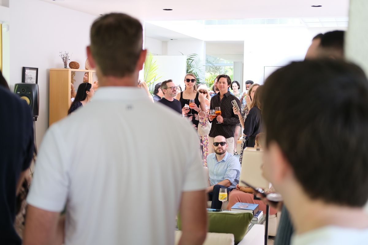 Guests mingling and talking at an indoor party